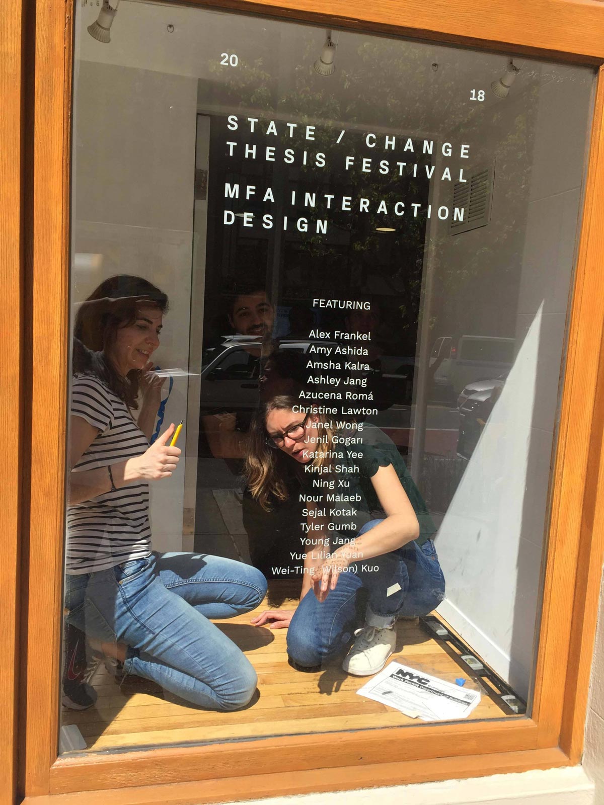 Glenda and Paula installing the type in the gallery window.